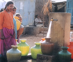 Grateful villagers draw water